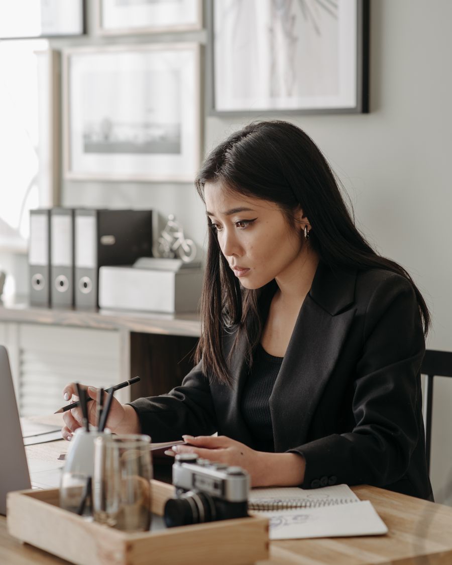 A person working carefully through a list of cold real estate leads at a laptop